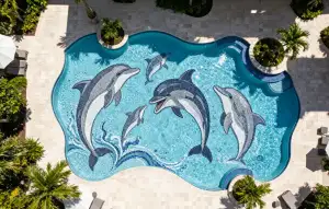 Aerial view of swimming pool with custom dolphin mosaic mural on the pool floor