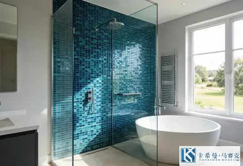 Luxury bathroom with deep blue and teal glass mosaic tile feature wall behind a freestanding bathtub