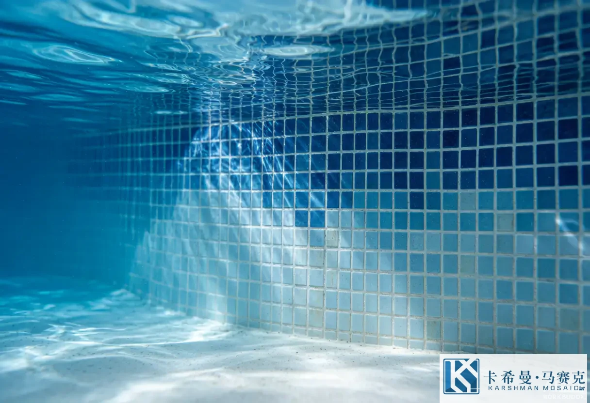 Gradient blue pool mosaic tiles transitioning from deep navy to pale sky blue across a pool wall, close detail