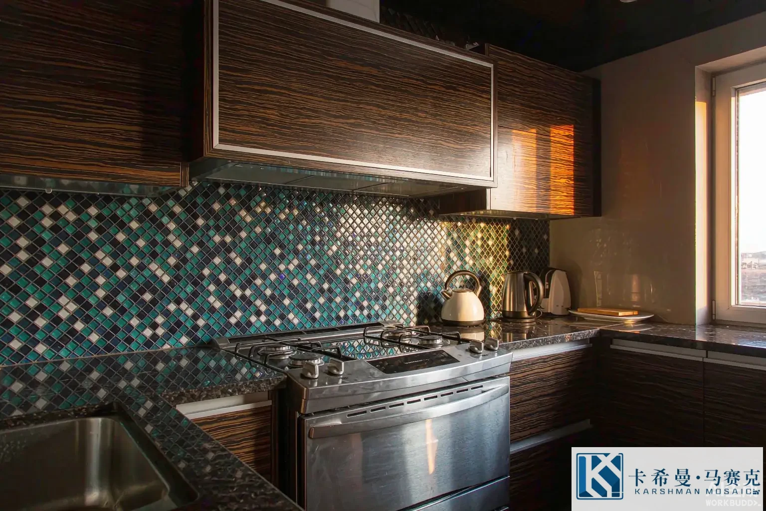 Modern kitchen with a teal and white glass mosaic backsplash behind a stainless stove, warm morning light from a window
